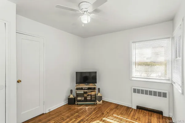 a bedroom with a bed and a tv