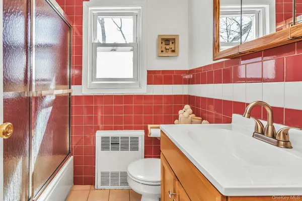 a bathroom with a sink a toilet and shower curtain