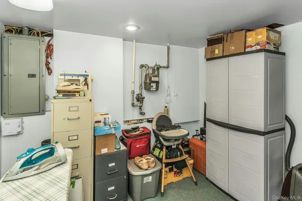 a view of a storage and utility room with a refrigerator