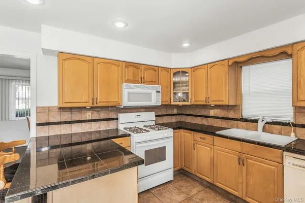 a kitchen with stainless steel appliances a stove sink and cabinets