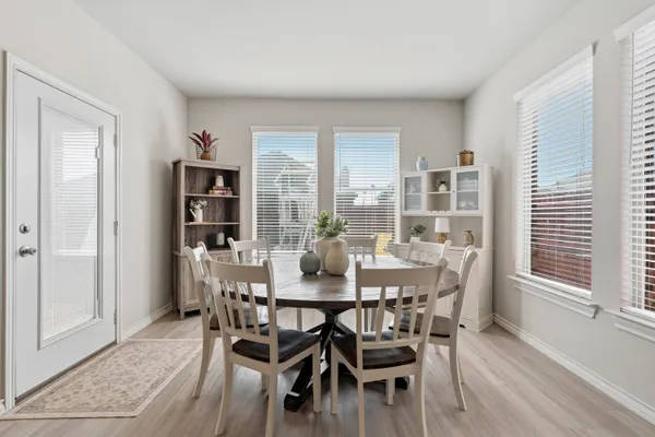 a view of a dining room with furniture and wooden floor
