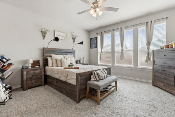 a bedroom with a bed and a chandelier