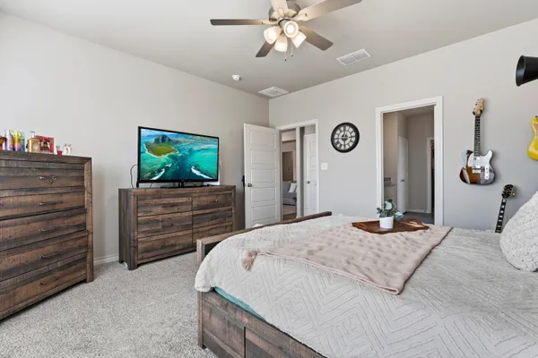 a bedroom with a bed and a flat screen tv