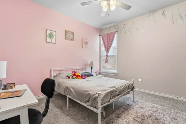 a bedroom with a bed and a table in it