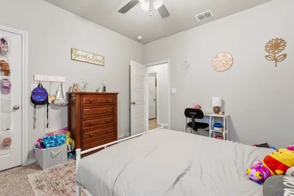 a bedroom with a bed and dresser