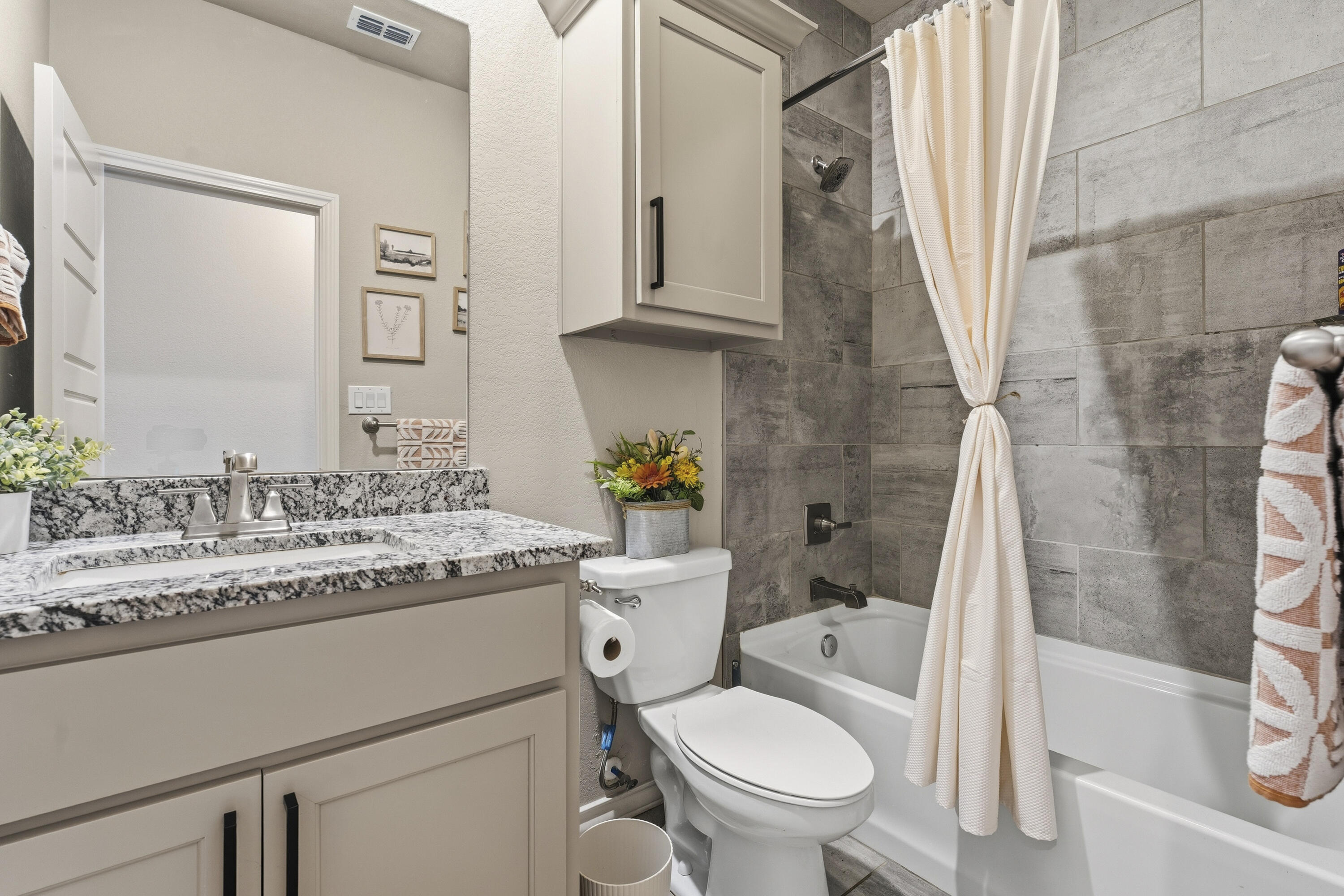 819 North 3rd Street Wolfforth, TX 79382 - Photo 21 of 31 a bathroom with a granite countertop toilet sink and mirror