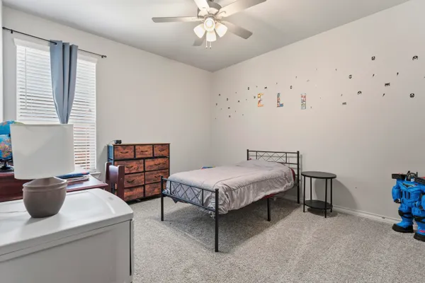 a bedroom with furniture and window