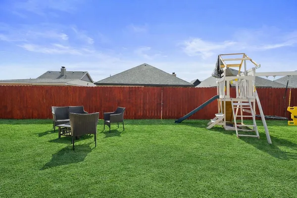 a view of a house with a yard and sitting area