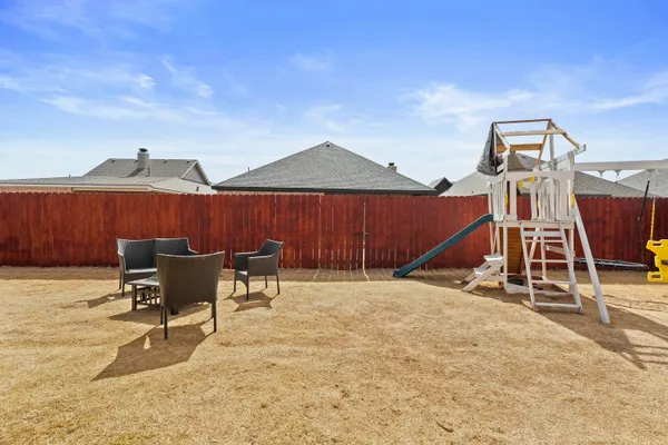 a view of a patio with a table and chairs