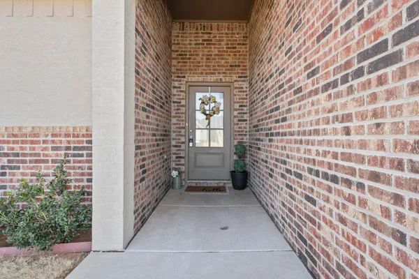 a view of entryway with brick walls