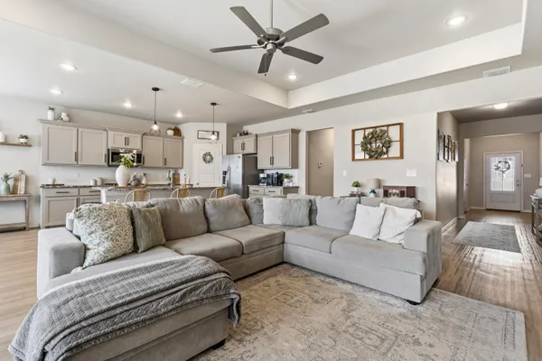 a living room with furniture and kitchen view