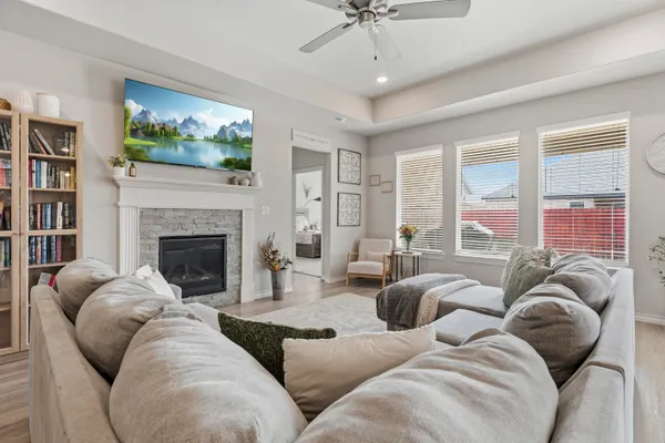 a living room with furniture large window and flat screen tv