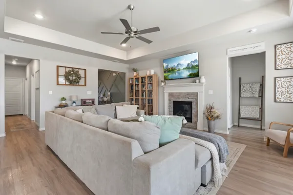 a living room with furniture a fireplace and a flat screen tv