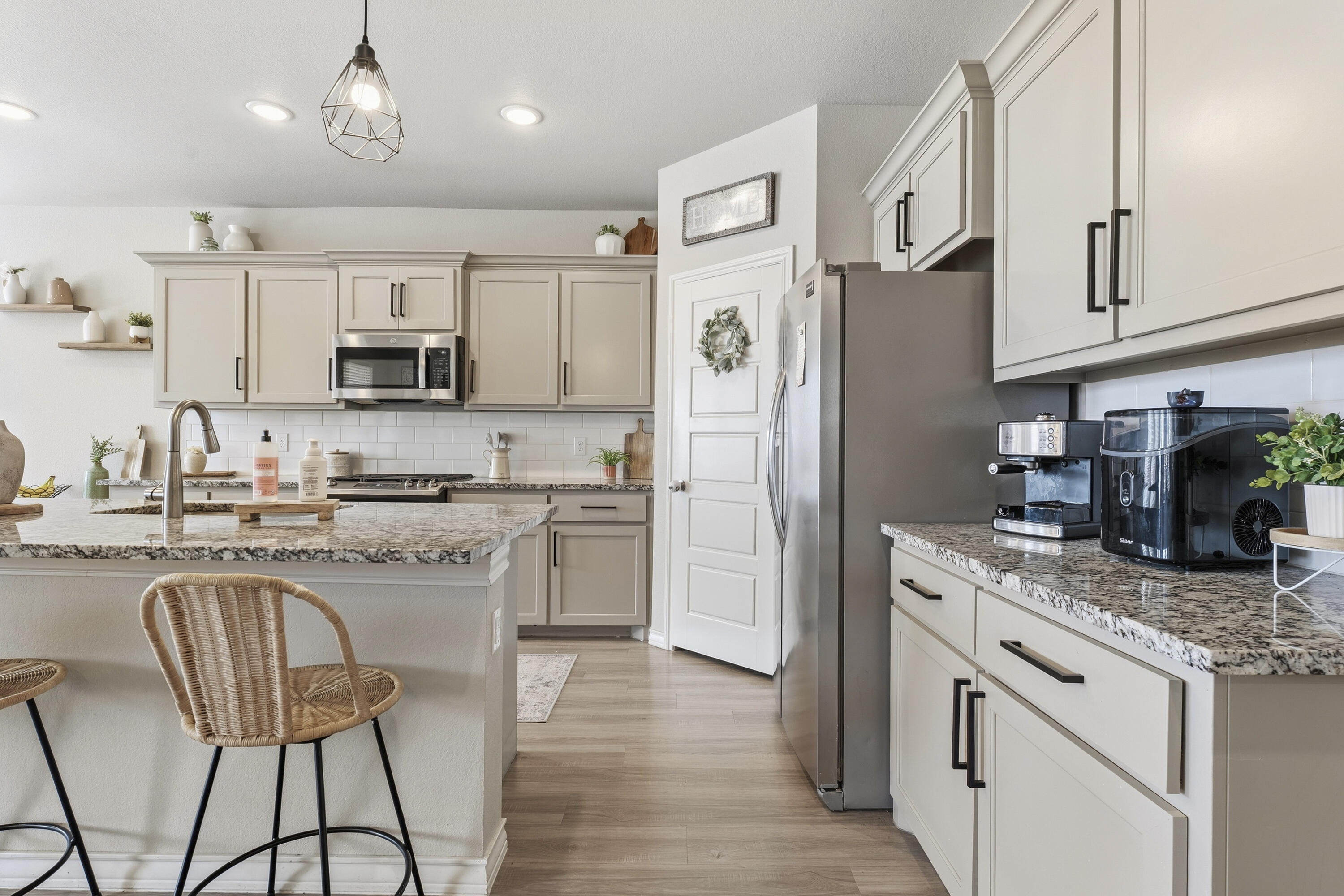 819 North 3rd Street Wolfforth, TX 79382 - Photo 8 of 31 a kitchen with stainless steel appliances granite countertop a refrigerator a stove a sink a dining table and chairs