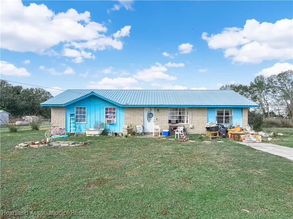 a view of a house with a yard and sitting area