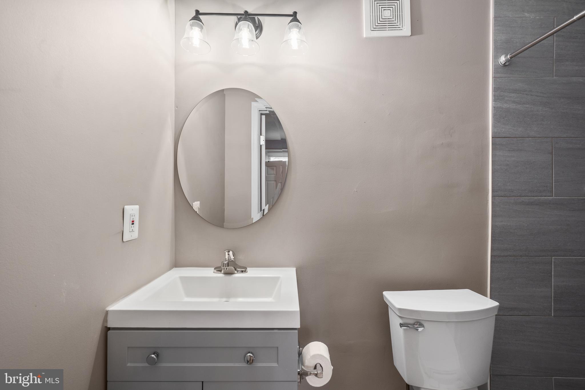 1526 V Street Southeast, Unit 2 Washington, DC 20020 - Photo 11 of 24 a bathroom with a sink mirror and toilet