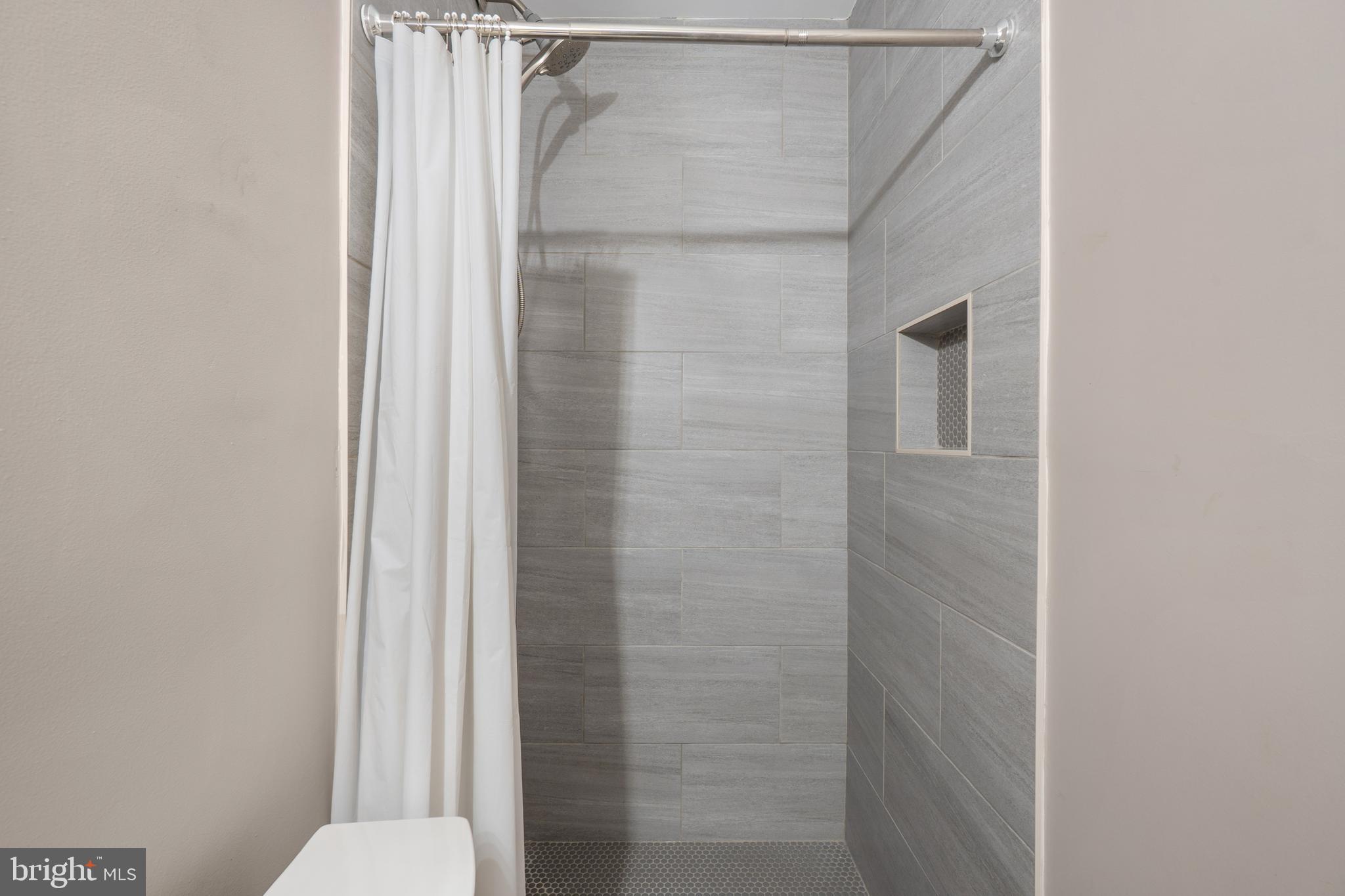 1526 V Street Southeast, Unit 2 Washington, DC 20020 - Photo 12 of 24 a bathroom with a granite countertop shower and a toilet