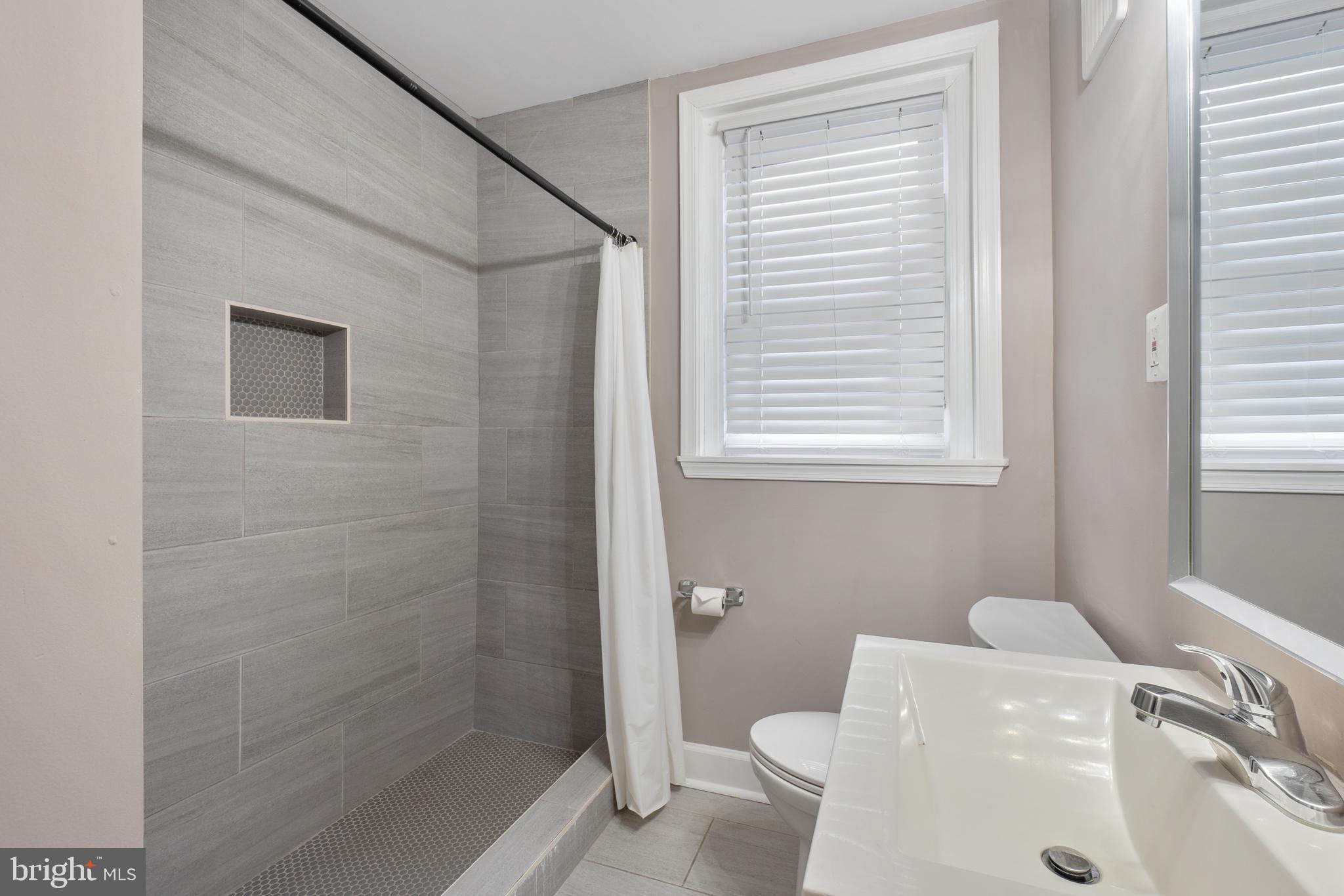1526 V Street Southeast, Unit 2 Washington, DC 20020 - Photo 16 of 24 a bathroom with a sink a toilet and shower