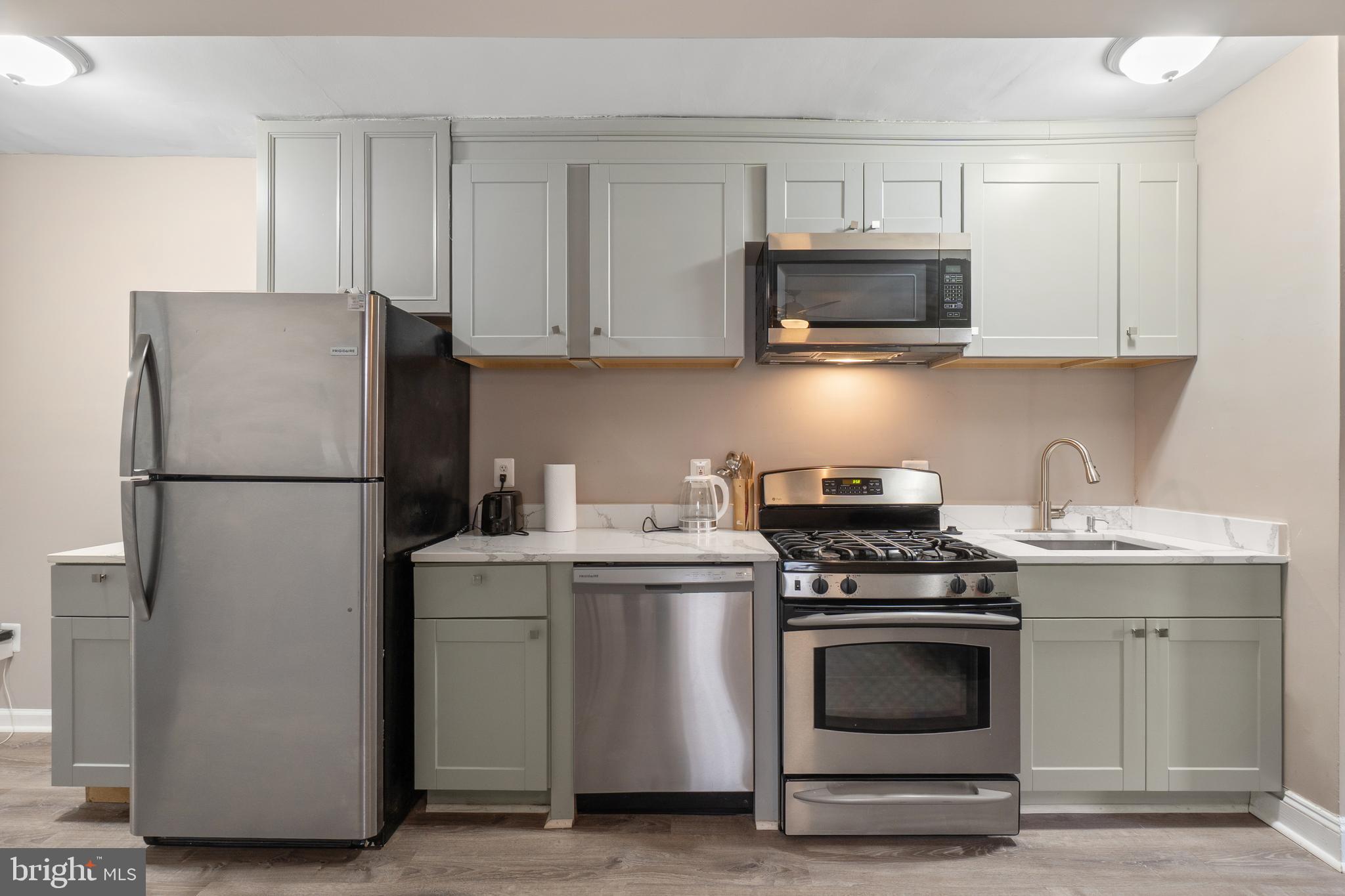 1526 V Street Southeast, Unit 2 Washington, DC 20020 - Photo 6 of 24 a kitchen with a stove and a refrigerator