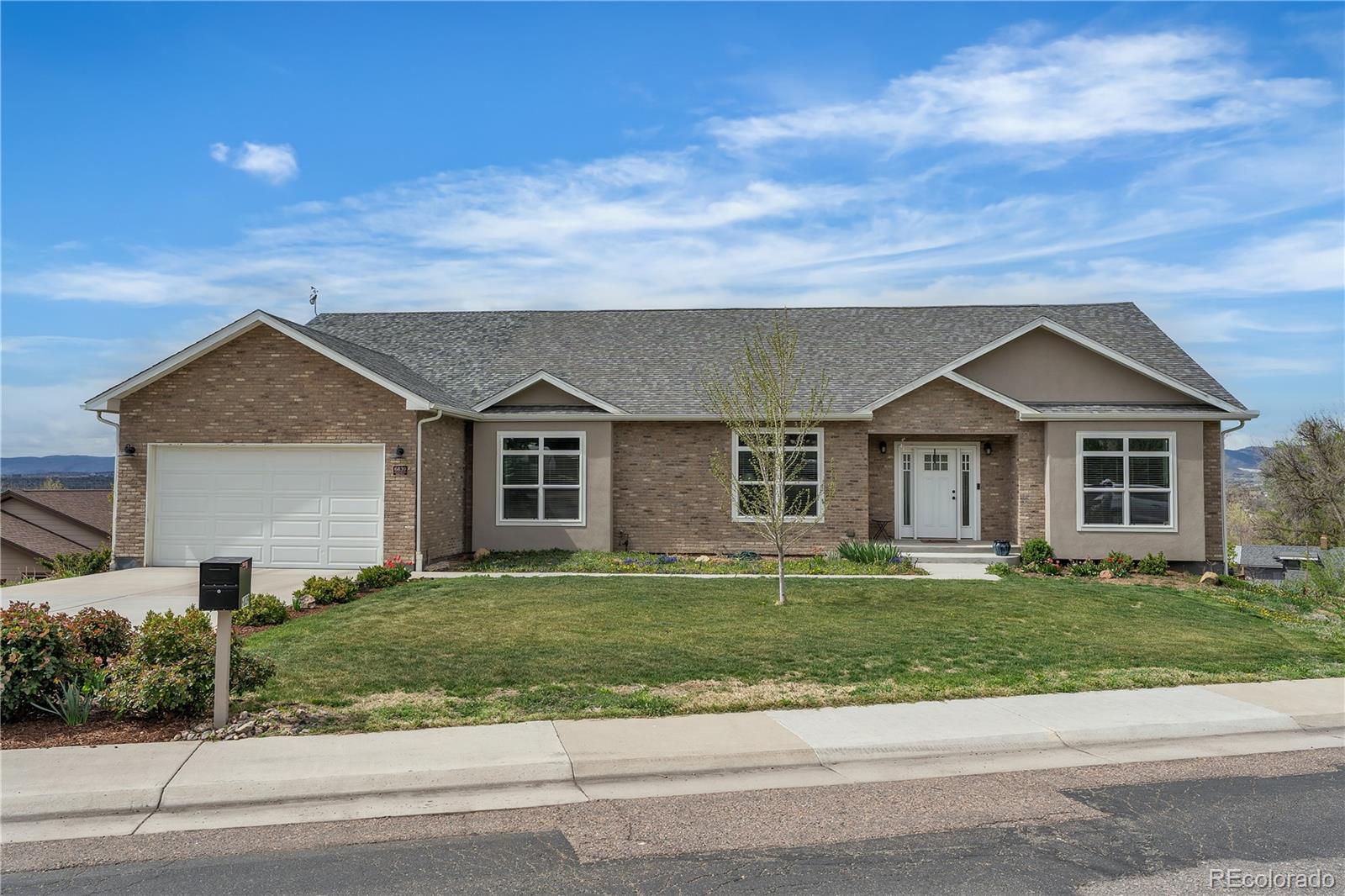 6839 Estes Drive Arvada, CO 80004 - Photo 1 of 34 a front view of a house with a yard