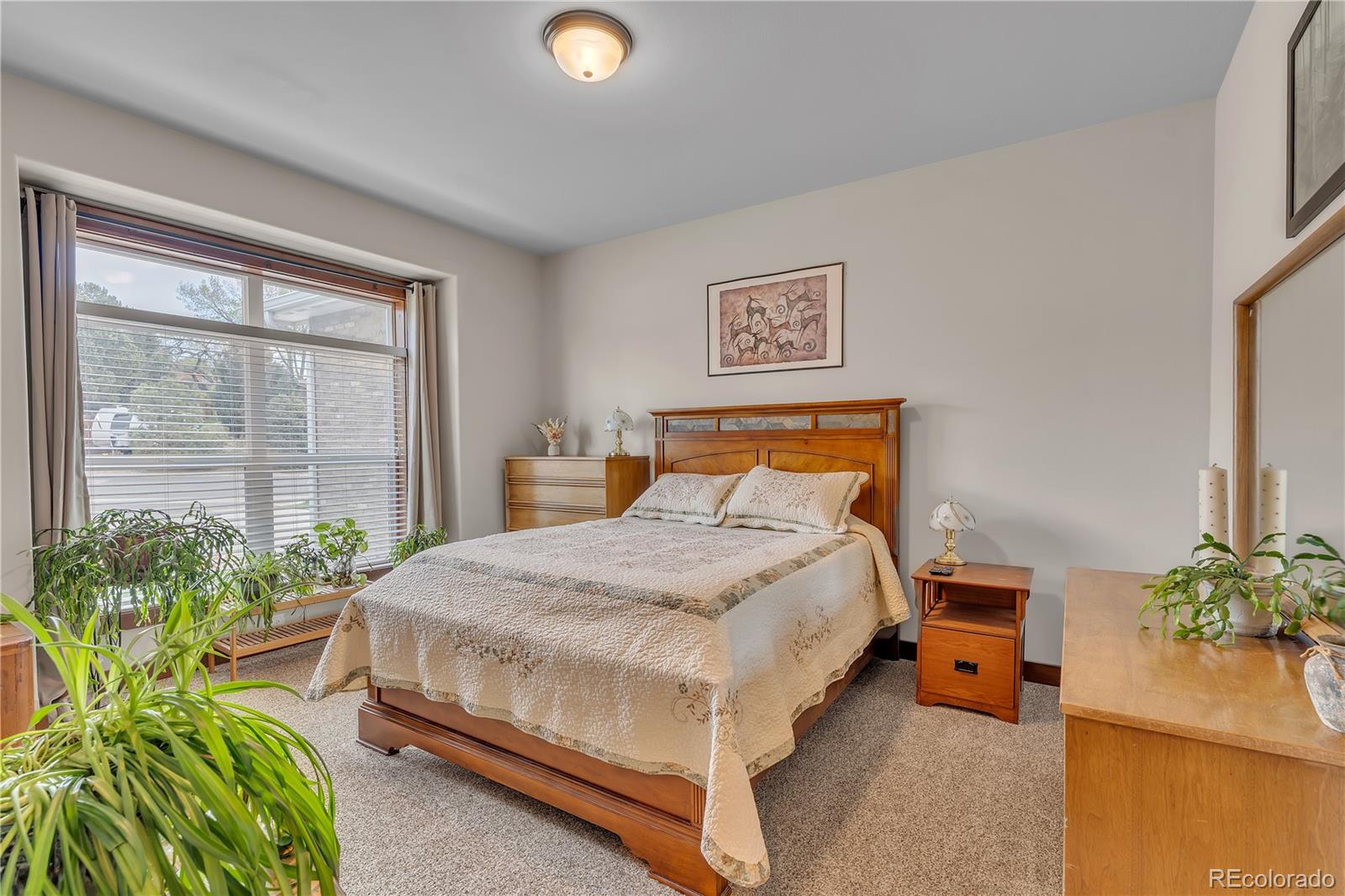6839 Estes Drive Arvada, CO 80004 - Photo 13 of 34 a bedroom with a bed and a large window
