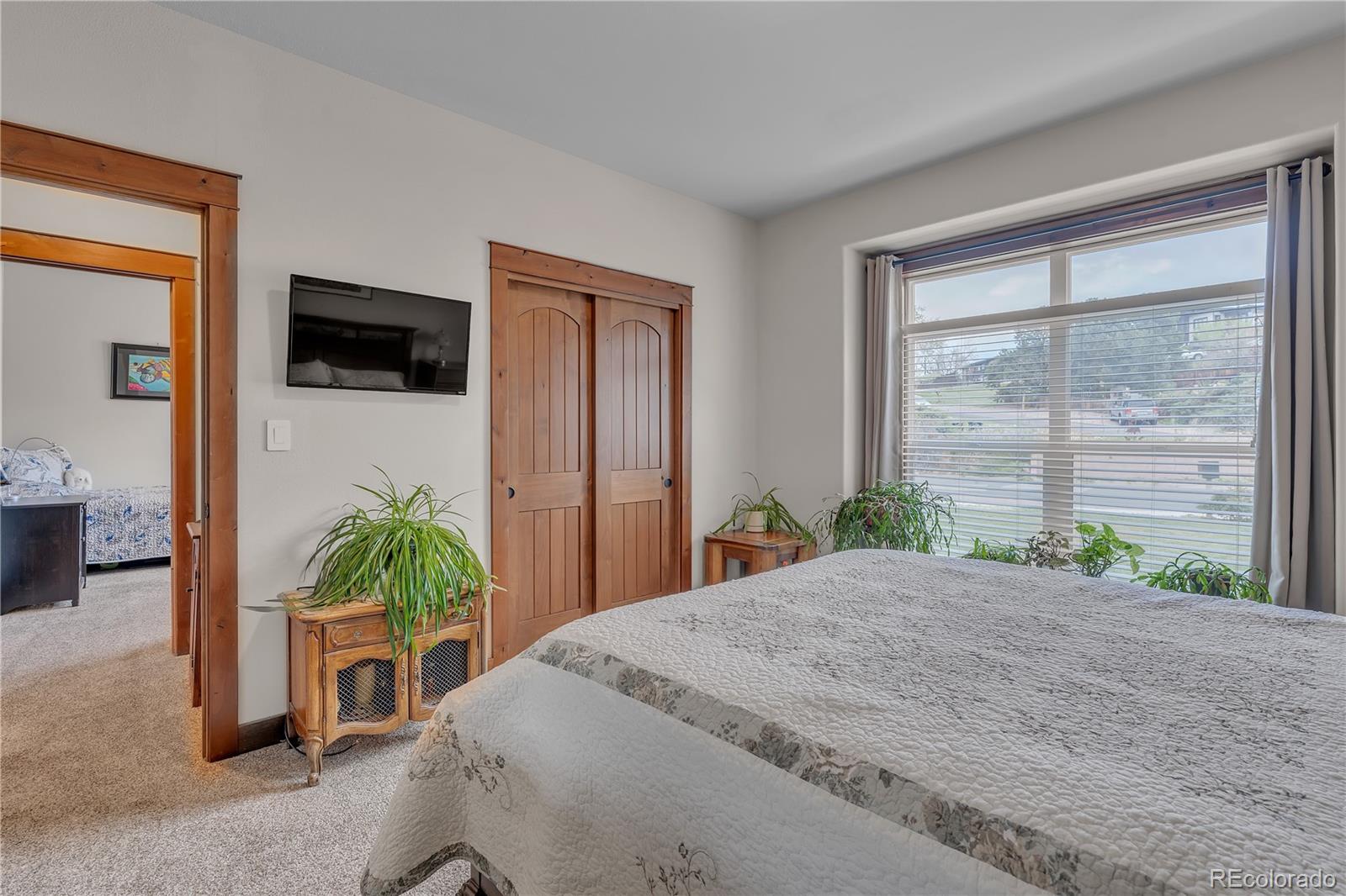 6839 Estes Drive Arvada, CO 80004 - Photo 14 of 34 a bedroom with a bed a window and a television