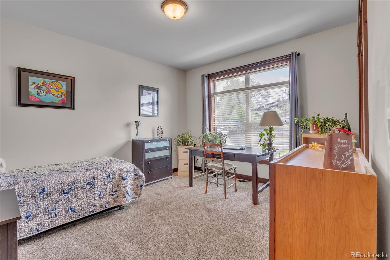 6839 Estes Drive Arvada, CO 80004 - Photo 15 of 34 a living room with furniture and a large window