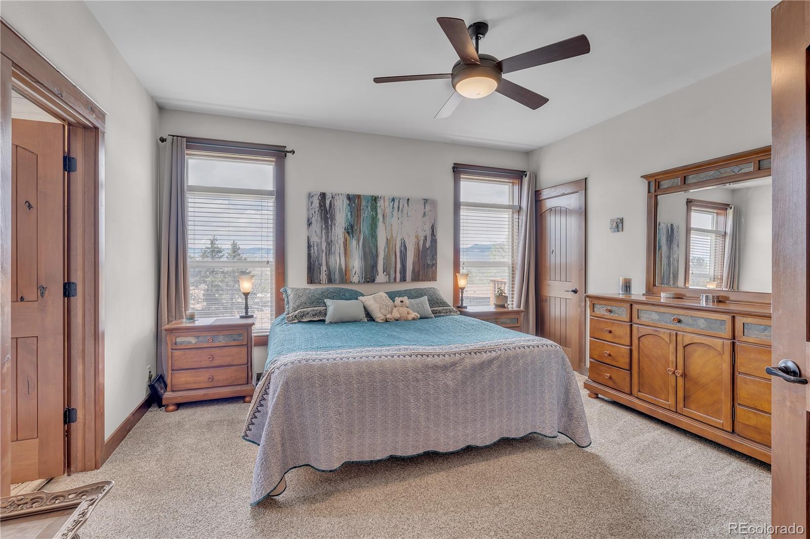 6839 Estes Drive Arvada, CO 80004 - Photo 18 of 34 a bedroom with a large bed and large windows