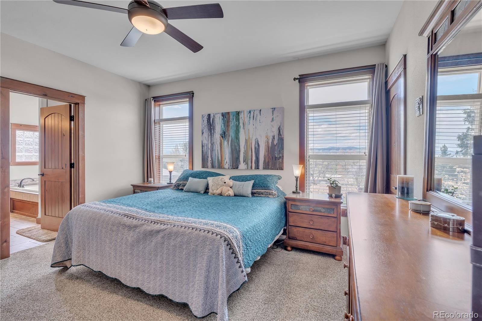 6839 Estes Drive Arvada, CO 80004 - Photo 20 of 34 a large bedroom with a bed and large windows