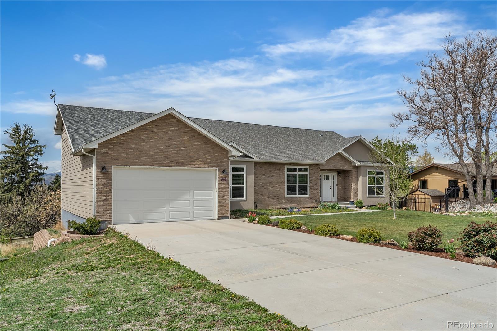 6839 Estes Drive Arvada, CO 80004 - Photo 2 of 34 front view of a house with a yard