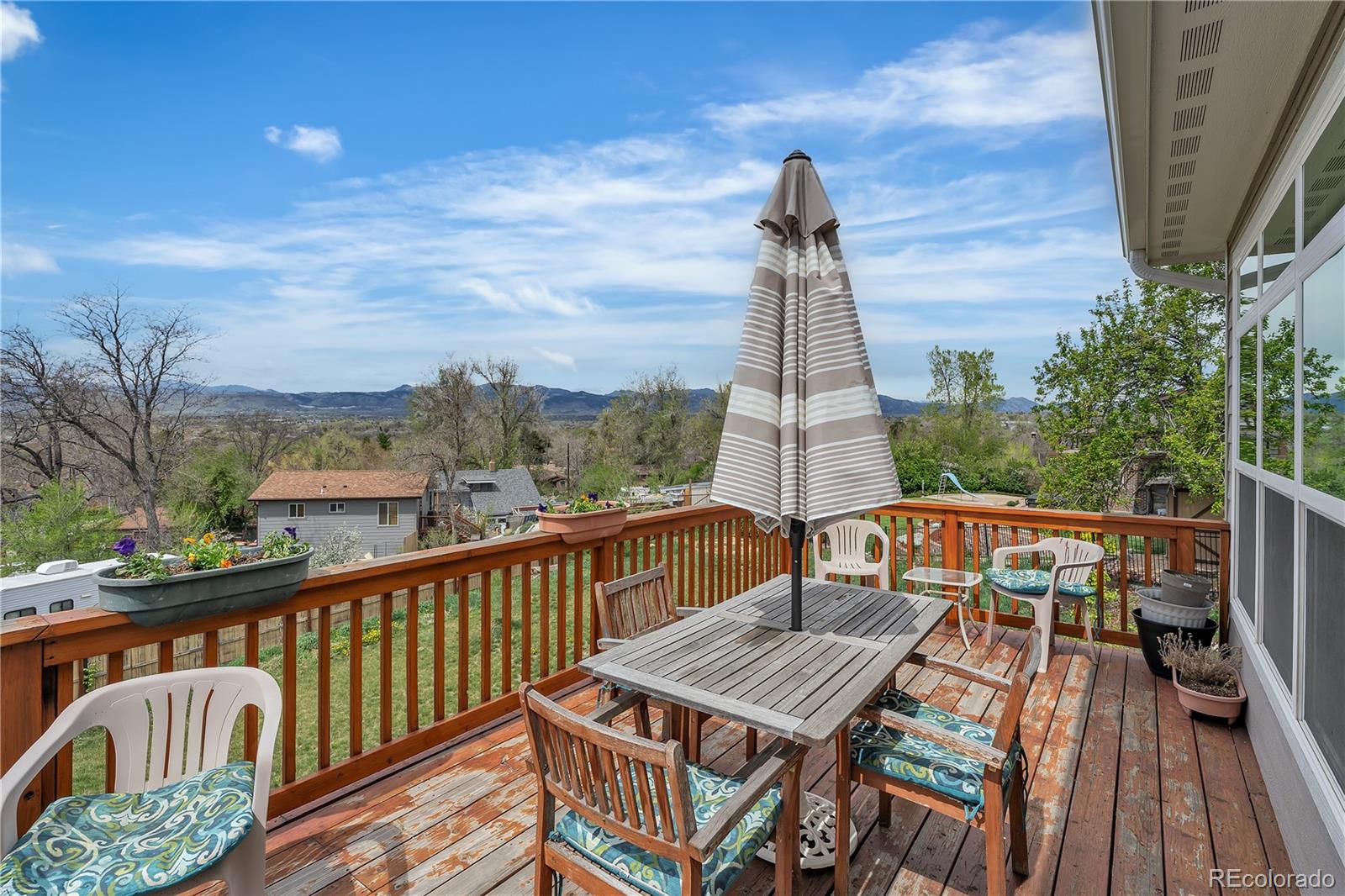 6839 Estes Drive Arvada, CO 80004 - Photo 25 of 34 a view of a deck with wooden floor and outdoor seating