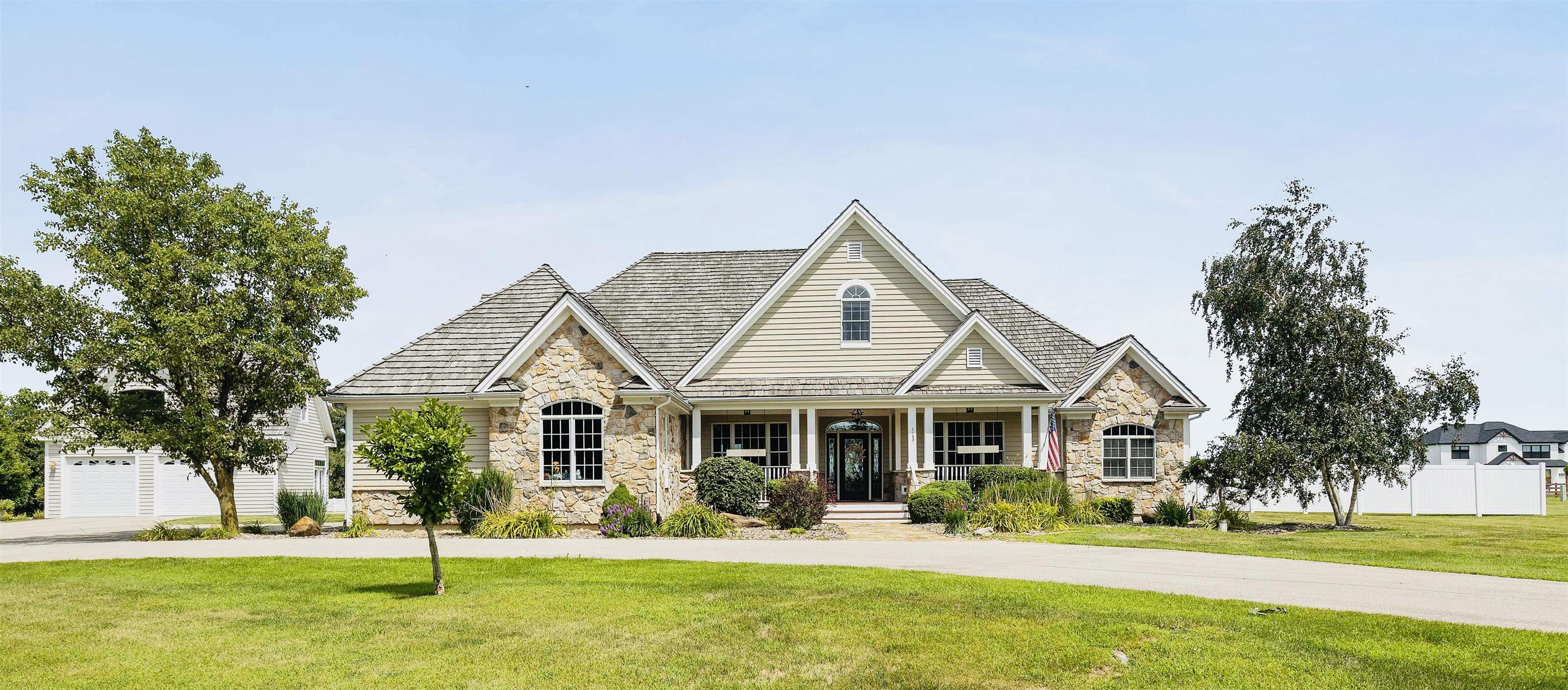 a front view of a house with a yard table and chairs