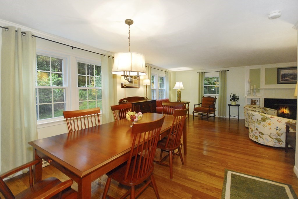 379 Stow Road Boxborough, MA 01719 - Photo 7 of 26 a view of a dining room with furniture a chandelier and wooden floor