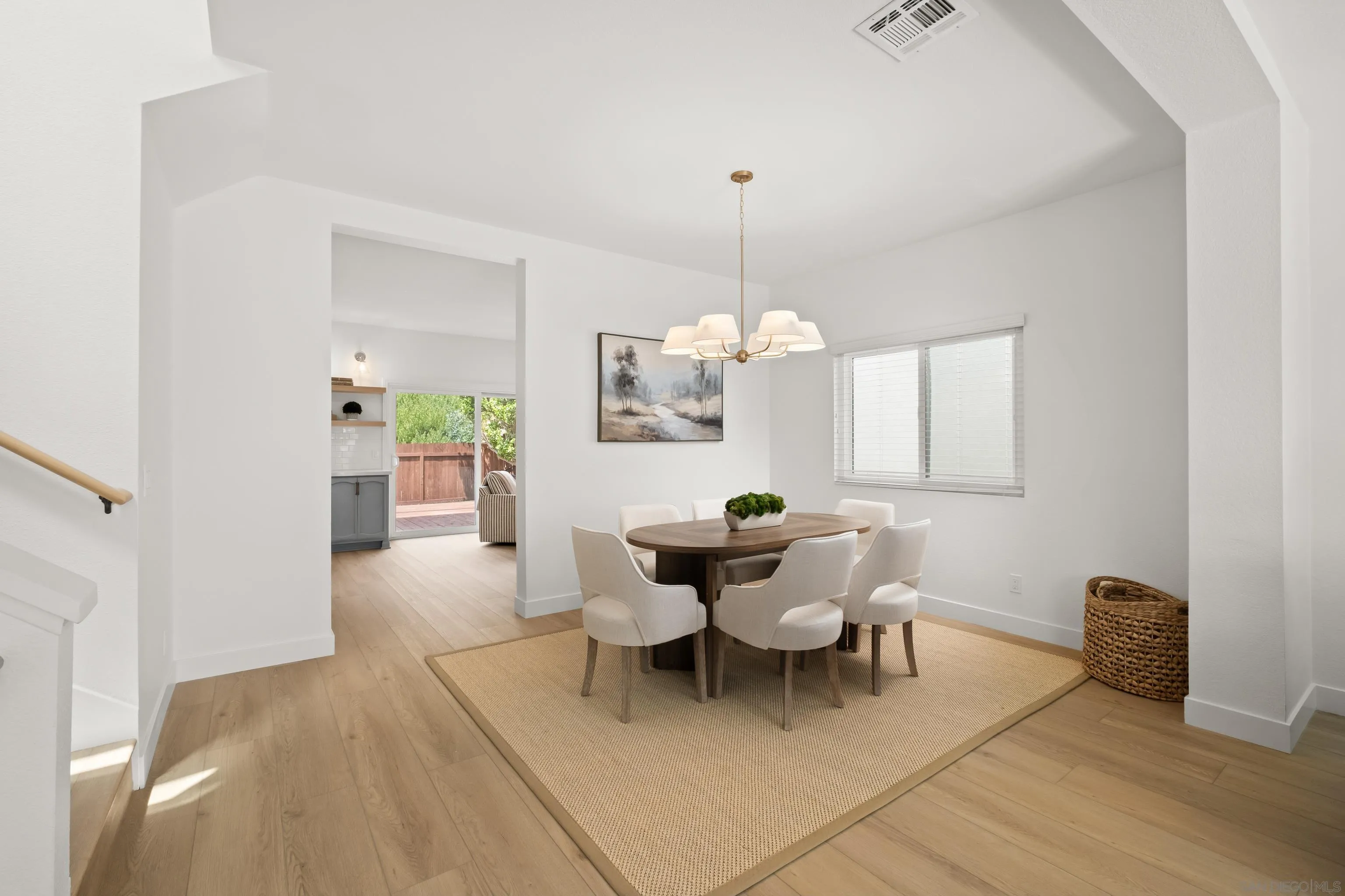 11478 Madera Rosa Way San Diego, CA 92124 - Photo 5 of 54 a view of a dining room and livingroom with furniture wooden floor a chandelier