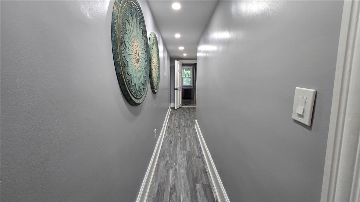 883 North Locust Street Hazleton, PA 18201 - Photo 50 of 83 Recessed lighting illuminates this inviting hallway, leading to a sunlit room beyond.