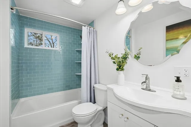 a view of a dining room and kitchen with furniture window and wooden floor