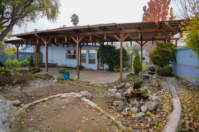 a view of a blue house with a yard