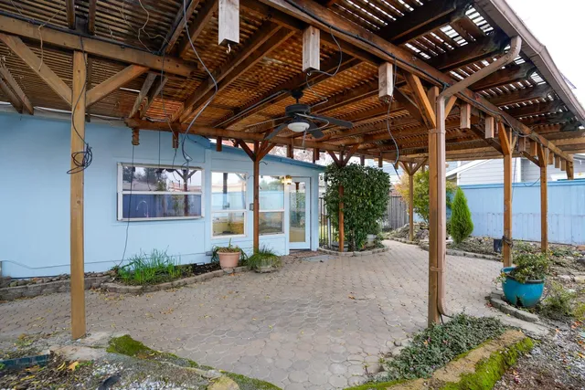 a view of a patio with table and chairs under an umbrella