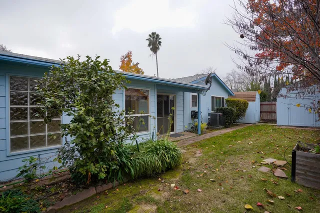 a view of a house with backyard and sitting area