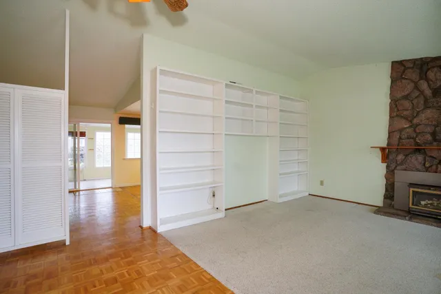 a view of an empty room and fire place