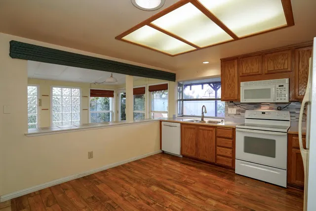 a kitchen with granite countertop a stove and a sink