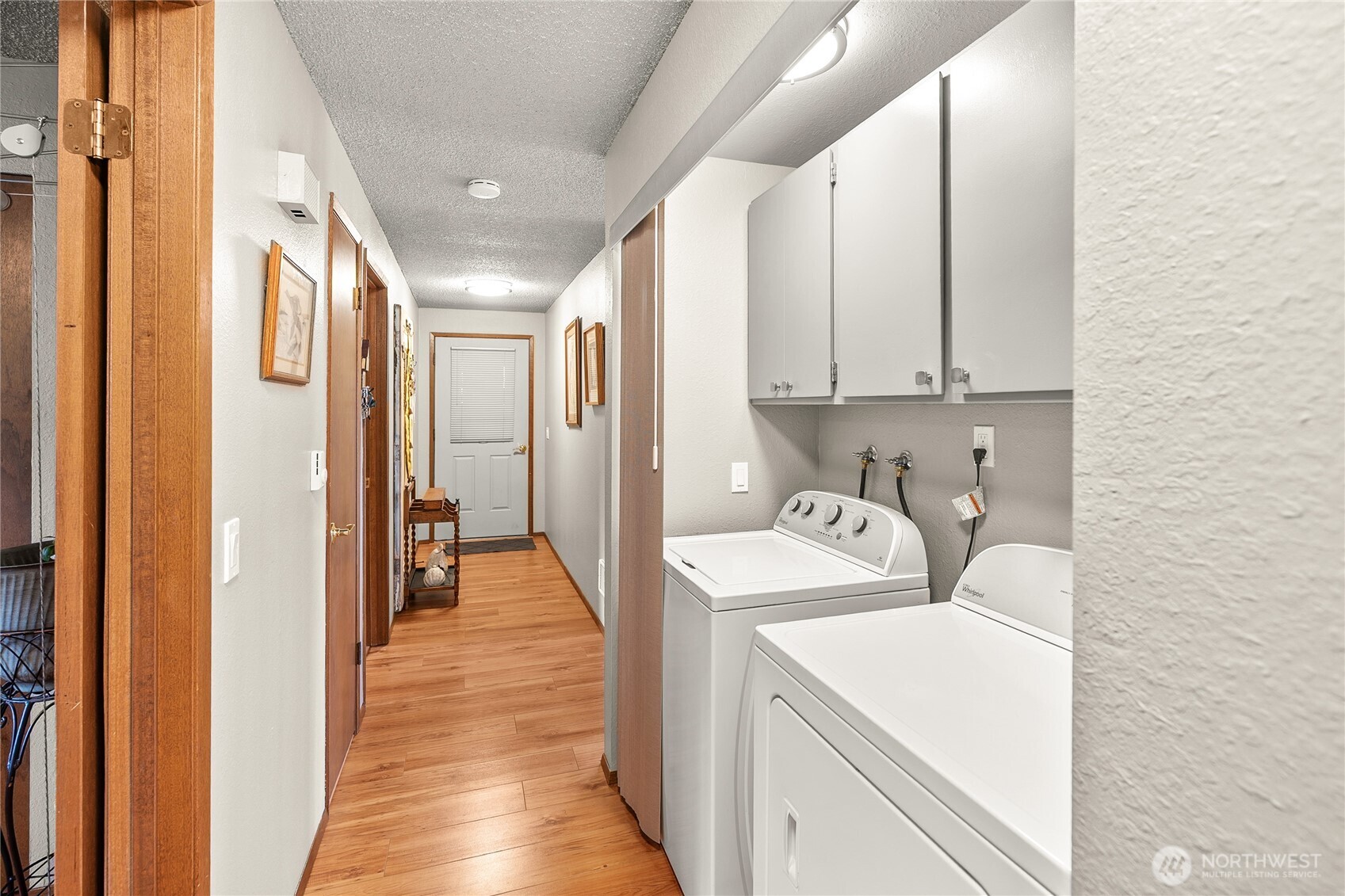 1301 South 3rd Avenue, Unit 15D Sequim, WA 98382 - Photo 14 of 26 a view of a hallway with washer and dryer