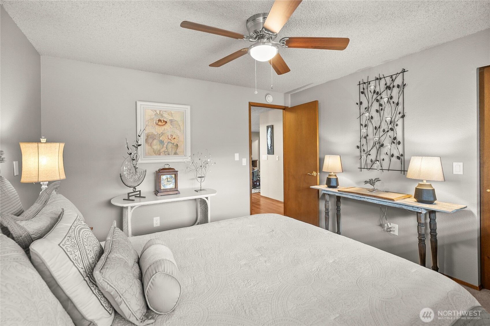 1301 South 3rd Avenue, Unit 15D Sequim, WA 98382 - Photo 16 of 26 a bedroom with a large bed and a chandelier