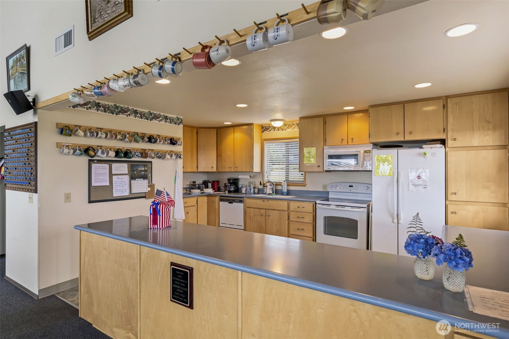 1301 South 3rd Avenue, Unit 15D Sequim, WA 98382 - Photo 23 of 26 a kitchen with stainless steel appliances kitchen island granite countertop a refrigerator and a stove top oven