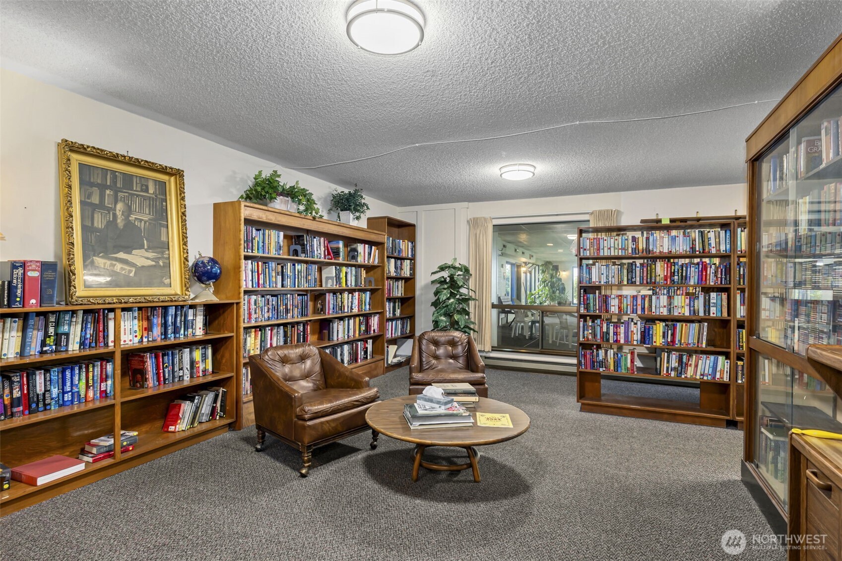 1301 South 3rd Avenue, Unit 15D Sequim, WA 98382 - Photo 25 of 26 a living room with furniture and a book shelf