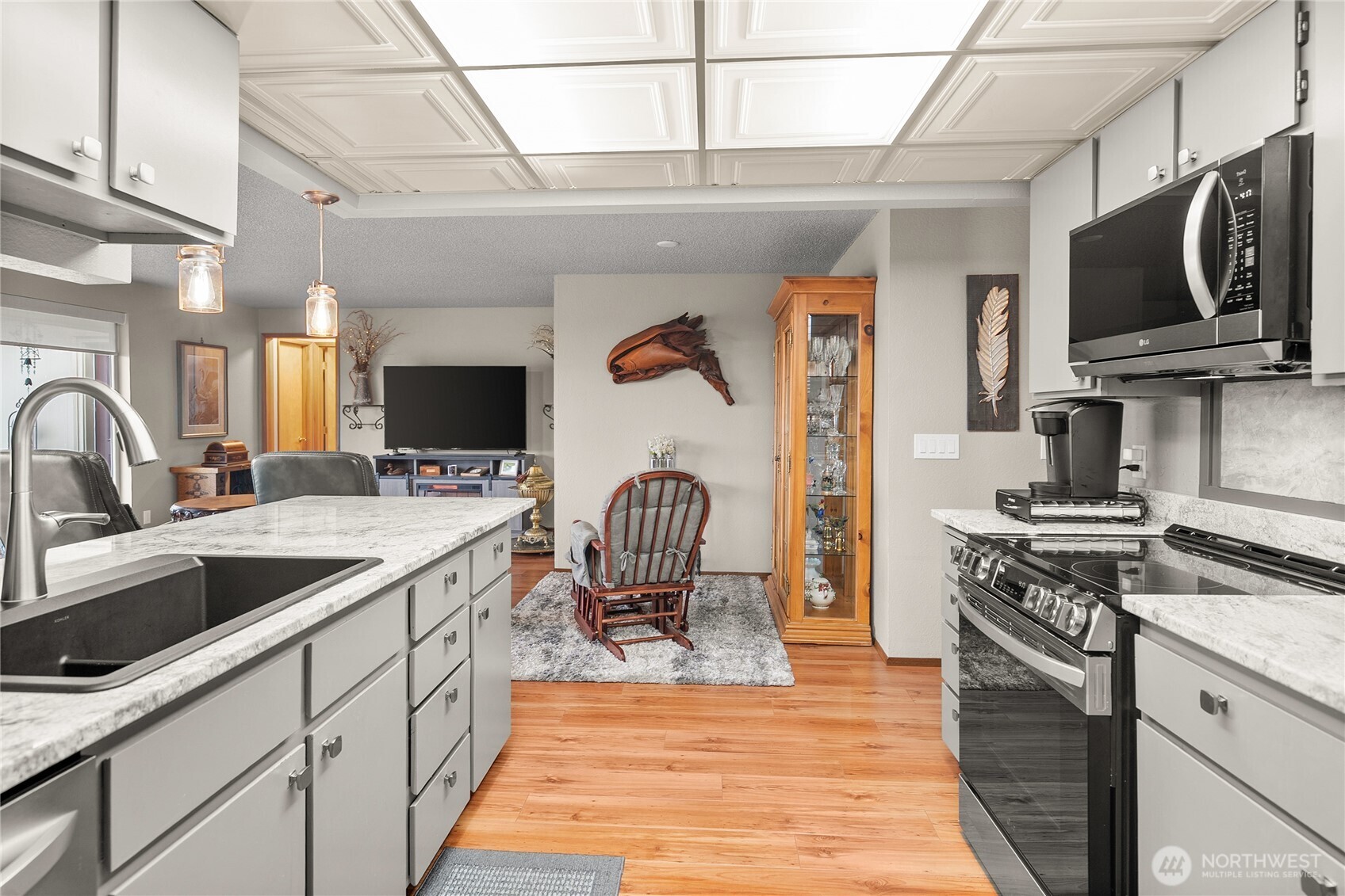 1301 South 3rd Avenue, Unit 15D Sequim, WA 98382 - Photo 4 of 26 a kitchen with stainless steel appliances granite countertop a sink dishwasher stove and refrigerator with wooden floor
