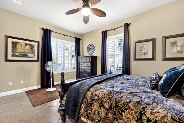 a bathroom with a granite countertop sink and a mirror with toilet