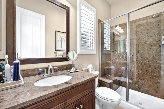 a view of a patio with table and chairs potted plants and large tree