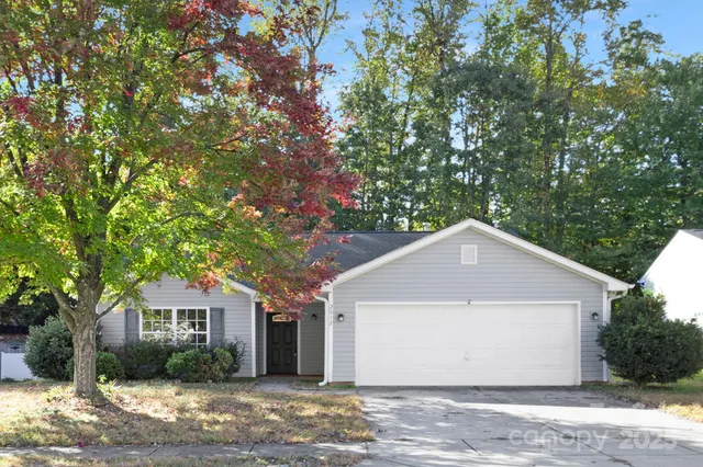 a front view of house with yard and trees