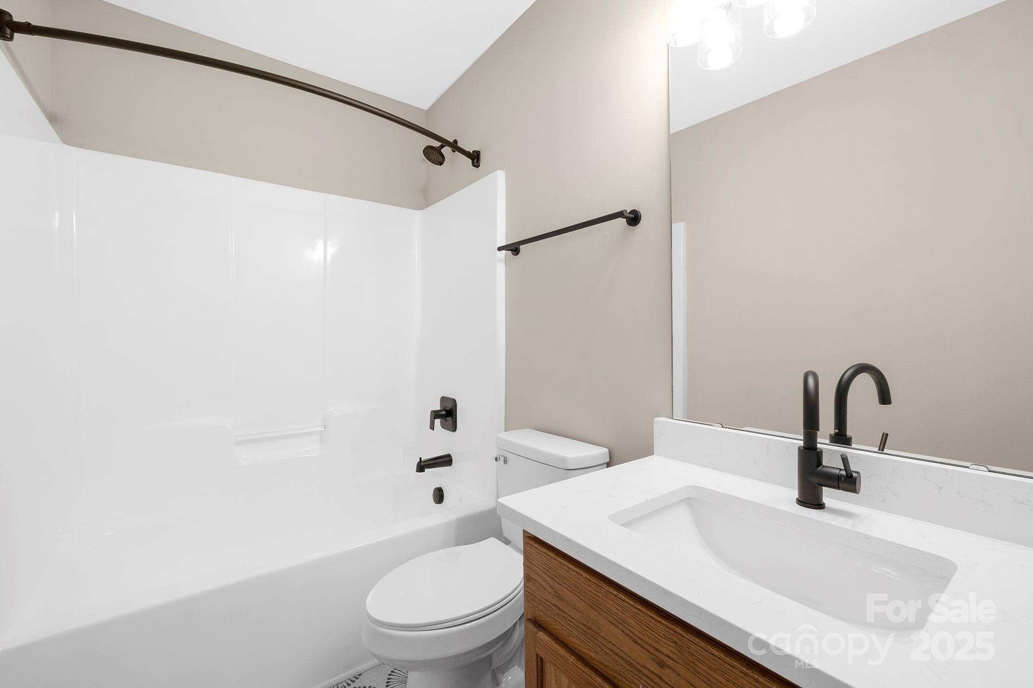 2012 Pheasant Glen Road Charlotte, NC 28214 - Photo 14 of 20 a bathroom with a sink toilet and shower